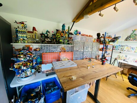 Another picture of the shed. In this one an MOC, the Death Spa is in the foreground. There's another table here, which is my standing build table. It has a microphone attached to one end. I do my monthly Live and Bricking Youtube shows from here.
