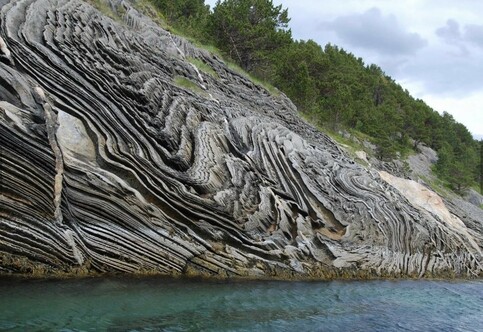 Spectacular folded on rock face along a shoreline in Saltstraumen, near Bodø in northern Norway.