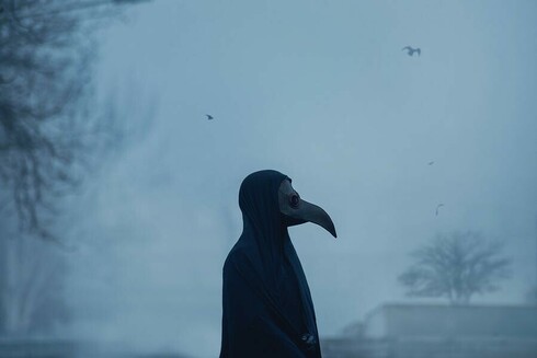 Person in beaked pandemic garb