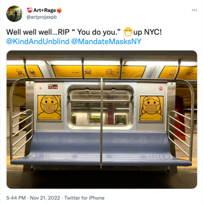 Picture of inside of an empty subway car with signs encouraging New Yorkers to mask up