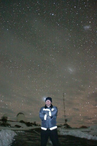 Me under the starry sky of the ESO La Silla Observatory, Chile. The Large and Small Magellanic Cloud are visible.