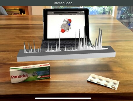 Paracetamol/Acetaminophen tablets on a table, behind them is an augmented reality version of the #Raman spectra of paracetamol and an iPad showing the molecular structure