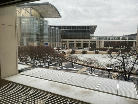 View of a convention center with AGU signs, and a light dusting of snow outside.