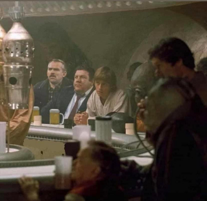 Luke Skywalker at the bar in the cantina on Tatooine. Coach and Norm from Cheers sit beside him.