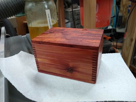 Small wooden box, made from cedar and box joints, and a padauk lid, finished with several coats of wipe on poly.  Box joints made on a table saw jig.