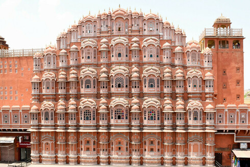Hawa Mahal - literally meaning the breezy palace, with its almost 1000 windows, all in glorious pink, located in Jaipur, India, which is also called the Pink City, due to such buildings that can be found aplenty. The windows follow the traditional architecture with arches, latticework, coloured glass, etc.