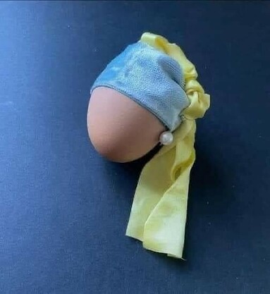 Egg dressed up with a piece of blue cloth and yellow cloth, with pearl earring, after Vermeer.