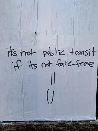 "It's not public transit if it's not fare-free" written on a wall with black marker