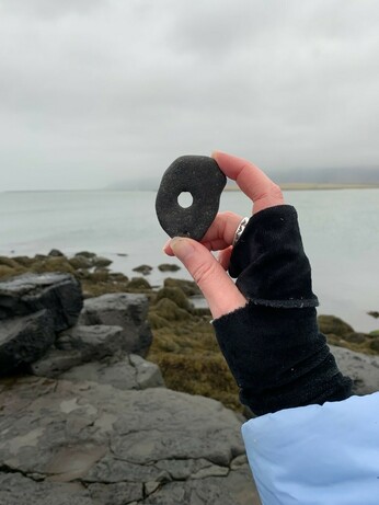 Magical adder stone held up to coastline