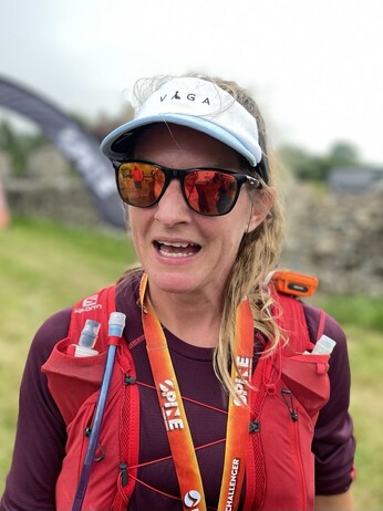 Mel Sykes, first woman in the Spine Challenger South, pictured with the finish line in the background