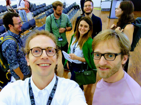 Photo portrait of the AMP team, Massimiliano Carloni, Nina Rastinger, Stephan Kurz, and Fabio Mariani at the DH2023 conference venue.