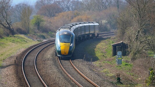 A Hitachi class 802 bi-mode electro-diesel rounds a curve on a non-electrified line