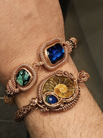 My ammonite wirewrap bracelet on the same wrist as my new glass gemstone bracelet