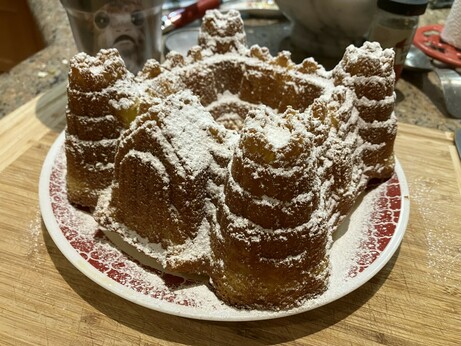A castle-shaped lemon cake with powdered sugar on top