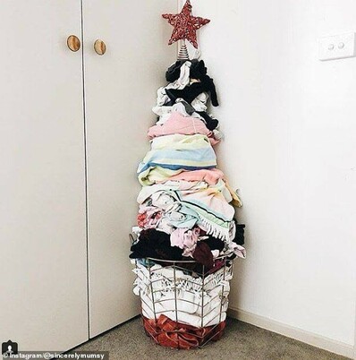 A Christmas tree composed of a laundry basket with the laundry piled up in the shape of a tree, topped by a star