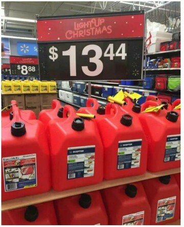 A store display of plastic gasoline canisters. Above it is a sign that reads "$13.44. Light Up Christmas"
