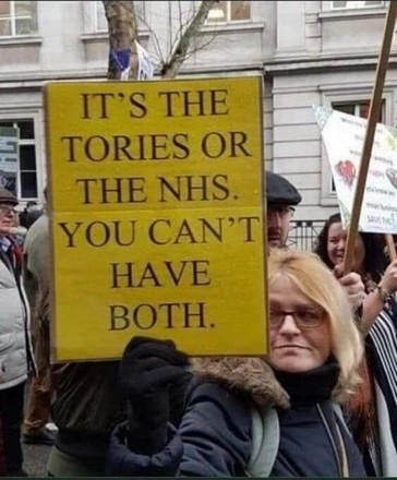 Woman at a protest march holding yellow sign that says "It's the Tories or the NHS. You can't have both"