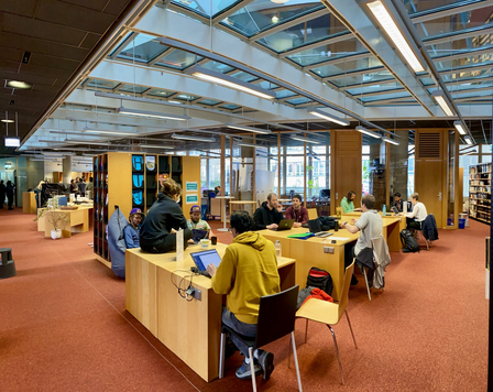 Hackathon participants in the library.
