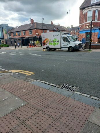 Delivery van parked on double yellow lines right beside a signal controlled crossing, blocking the view of the road for pedestrians. This view shows its also right beside a junction.