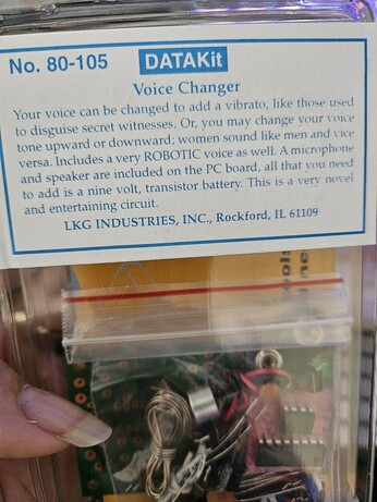 Soldering project kit for a DATAKit Voice Changer effect in a plastic bag. PCB and components visible beneath a simple printed sticker label.