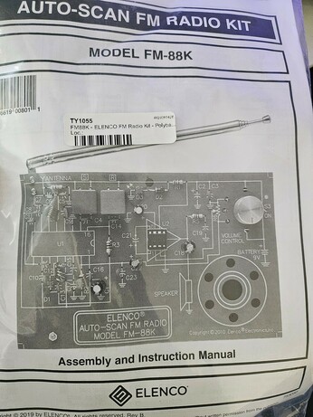Soldering project kit, with assembly and instruction manual for an ELENCO Auto-Scan FM radio.