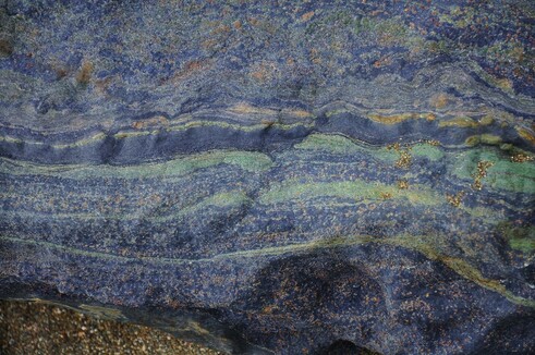 Blueschist rock with green retrograde omphacite and brownish garnets. Source: http://downtoearthquestions.blogspot.com/2013/08/brittle-ductile-deformation-in.html