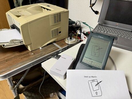 A Newton 120, an AsanteTalk. And a laser printer. There is a crudely drawn picture on a printout and the newton display