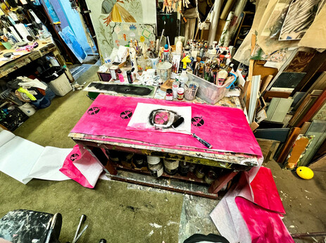 Painting a roll of butcher paper pink and then stenciling it down the center in my mom's shop.