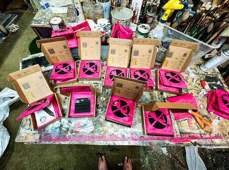A table full of packed Jumperless boxes