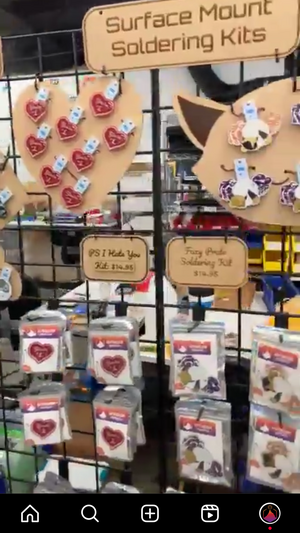 Colorful surface mount soldering kits displayed on gridwall, featuring red hearts and purple foxes!