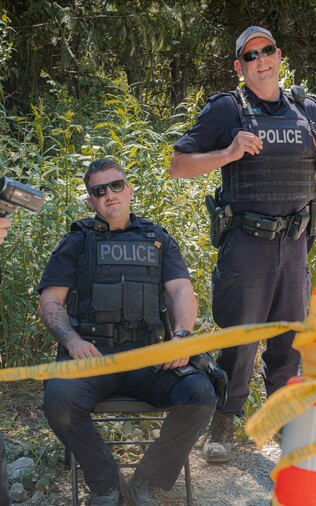 2 white RCMP CIRG chump guys. Both wearing thin blue line patch & no ID badges. The chump sitting down has a moosehide pin on him too.