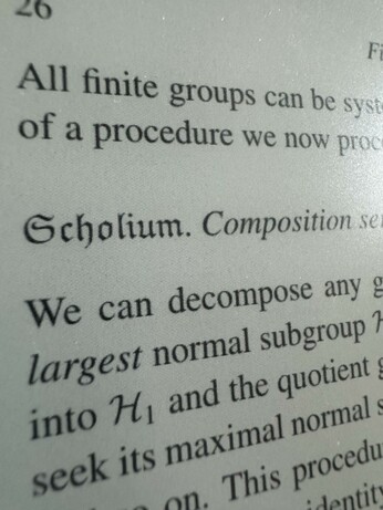 A page from textbook with “Scholium” written in a gothic font
