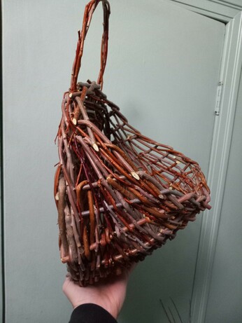 Side view of the same basket showing the flat-backed shape.