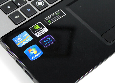 A close-up photo of the palmrest on an older PC laptop, with no less than five different stickers. Remove all of them.

This is the Way.