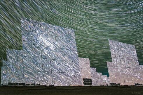 During the night the mirrors stand motionless though. They reflect the light of the countless distant stars, clusters and nebulae of the Milky Way and beyond. This sci-fi night skyscape was created with a camera fixed to a tripod near the edge of the giant mirror matrix on September 15. The camera's combined sequence of digital exposures captures concentric arcs of celestial star trails through the night with star trails in surreal mirrored reflection.