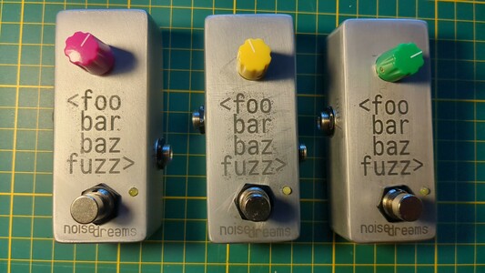 Three copies of the foobarbaz fuzz guitar pedal, view from the upside