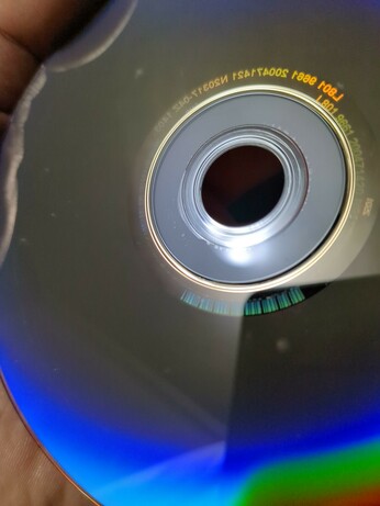 A photo of one of my DVDs. Towards the center of the disc you can see a few bubbles and a spot where the layers are beginning to come apart.