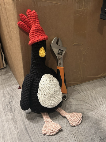 The same stuffed toy Feathers McGraw holding an adjustable wrench and looking mightily suspicious