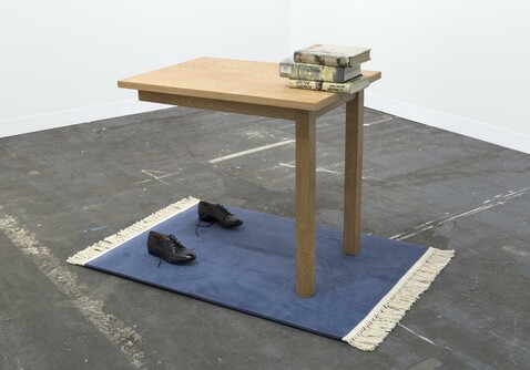 Two Leg Table by Jamie Isenstein, 2016 (shoes, rug, table, books, supports)