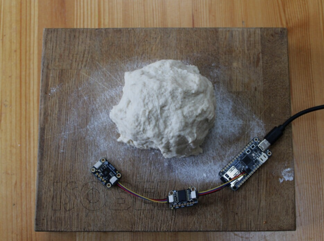 some floury dough with a circuit and cables near it
