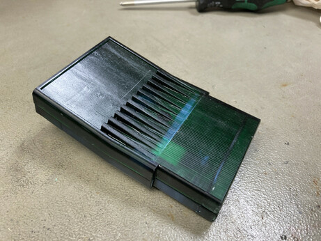 A 3d printed Commodore 16/116/Plus 4 cartridge shell (printed in clear green resin) with the Magic 264 Cart PCB inside on my workbench.