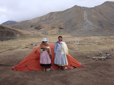 these two young women from the base village hire out as porters. they slung 25-30kg loads over their neck, hanging in front. up steep rocky trail from 4300-5640m. after hour break up there -10C lite wind, they descended back down.
