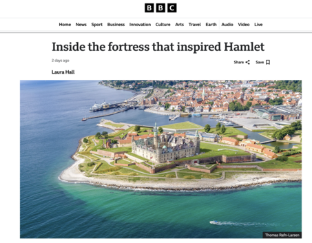 Photo of BBC Webpage with the headline "Inside the fortress that inspired Hamlet." Under the headline is the name of the author, Laura Hall. Under this is an aerial photo of Kronborg Castle in Helsingør, Denmark - the castle that inspired Elsinore in Shakespeare's play Hamlet. It is a lovely sunny day and the peninsula has white sand beaches. The castle is surrounded by green lawns and trees. In the background is a gown and harbour.