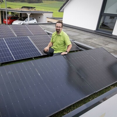 Gunther sitting between solar panels
