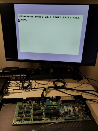 The Commodore 16 still with the top of the case and the keyboard removed, running with the modulator replacement.