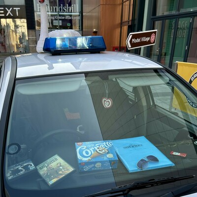 White Vauxhall Astra marked as a "Sandford Constabulary Police" car. Items from the film on the dashboard.