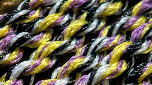 Purple, yellow, white, and black yo-yo string