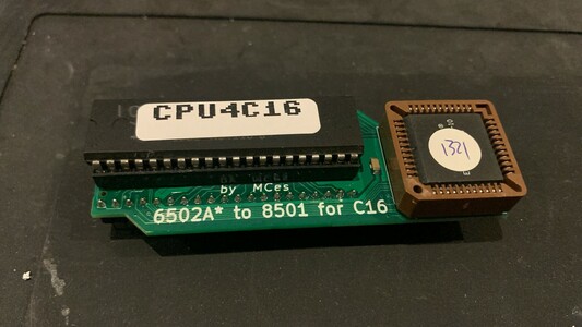 A small green PCB with a square PLCC chip and a DIP40 chip, the latter being the 6502 CPU.
