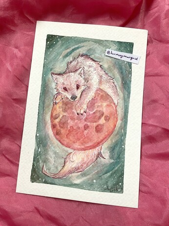 Photo of a small painting. It’s of a wolf climbing over a red moon.