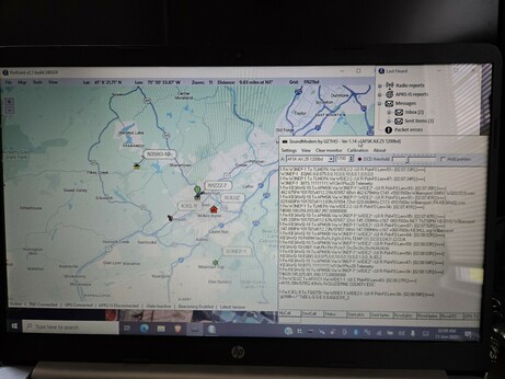 Screen shot of APRS map with TNC sceen showing raw packet data.